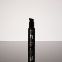 Black anal lube bottle labeled 'drip' on a reflective surface Oil based lubricant.