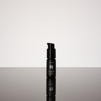 Black water based lube bottle with visible brand name on a gradient gray background, anal lubricants and sexual lubes.