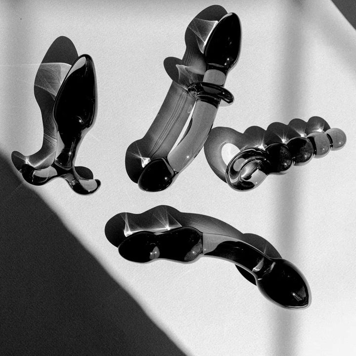 An image of four different sex toys (dildos and butt plug)