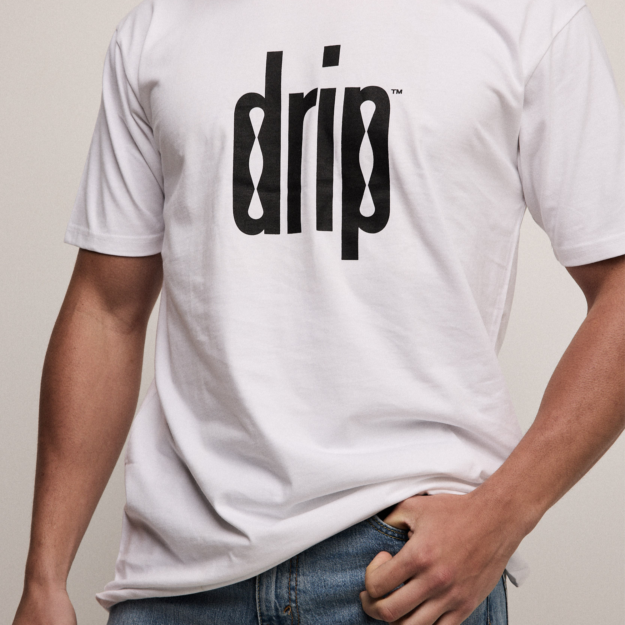 Person wearing a white t-shirt with 'drip' logo on a plain background