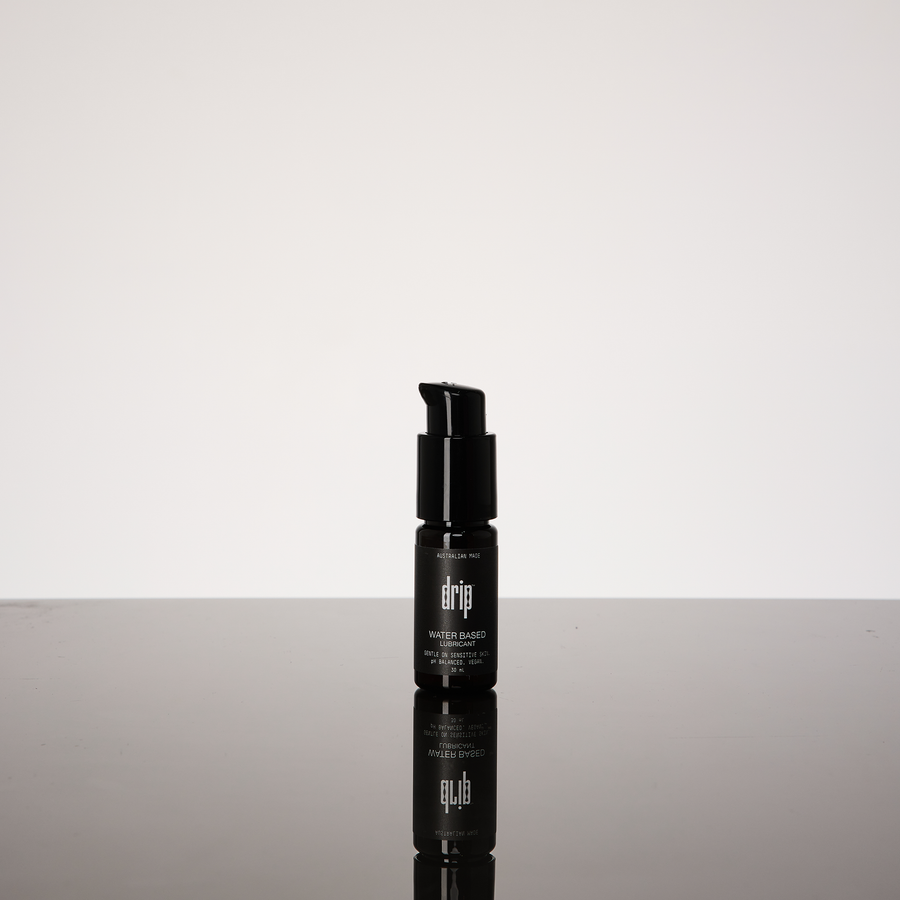 Black water based lube bottle with visible brand name on a gradient gray background, anal lubricants and sexual lubes.